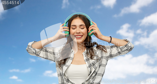 Image of happy young woman or teenage girl with headphones