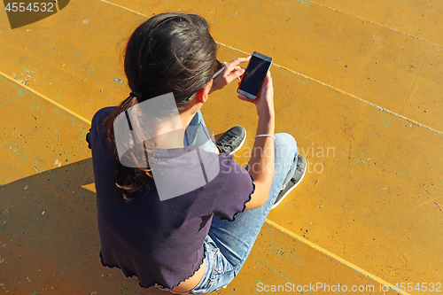 Image of Young girl use smartphon