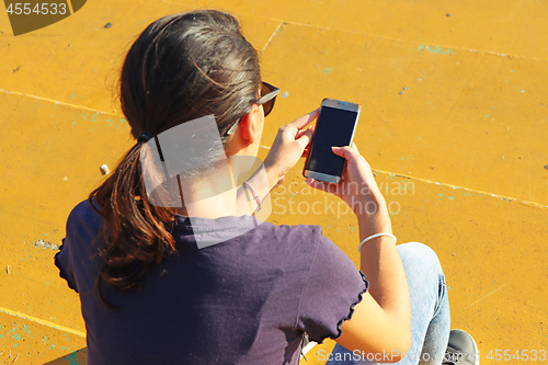 Image of Young girl use smartphon
