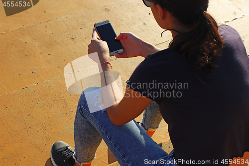 Image of Young girl use smartphon