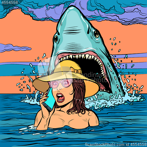 Image of A shark attacks a woman at sea. The girl asks for help on the phone