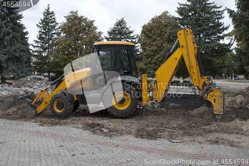 Image of excavator stands on the ground