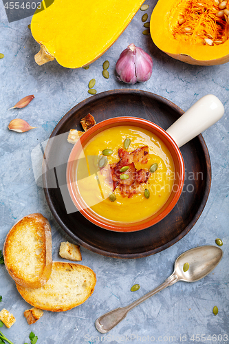 Image of Homemade pumpkin soup with crunchy bacon.