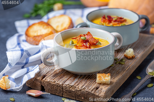 Image of Pumpkin soup with bacon in a rustic style.