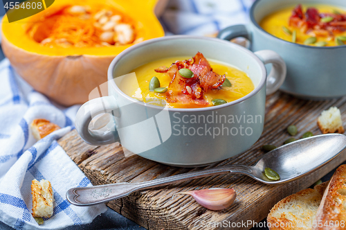 Image of Pumpkin soup with crispy bacon close up.