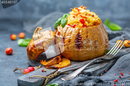Image of Ripe pumpkin baked with couscous and vegetables.