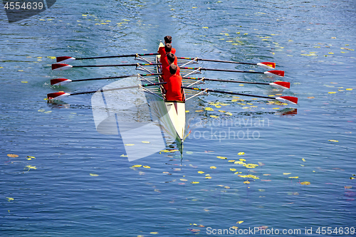 Image of Men's quadruple rowing team on blue water