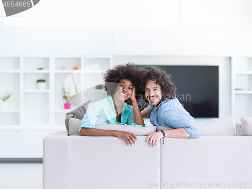 Image of young multiethnic couple in living room