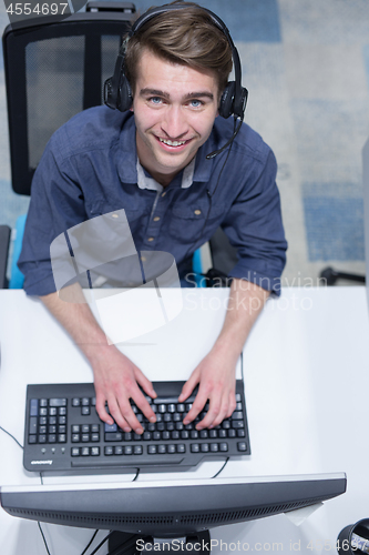 Image of male call centre operator doing his job top view