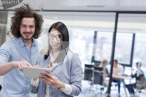 Image of Business People Working With Tablet in startup office