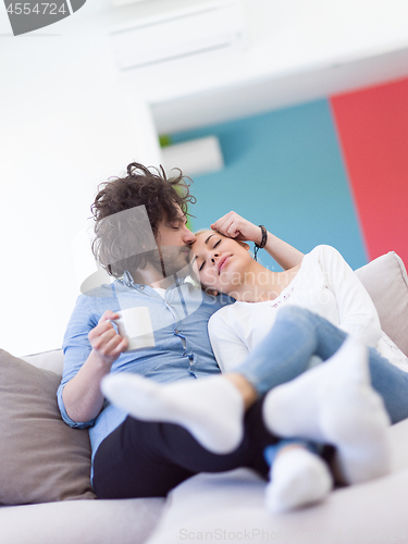 Image of Young couple on the sofa watching television