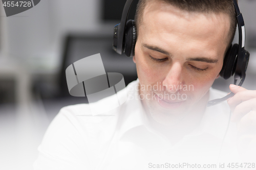 Image of male call centre operator doing his job