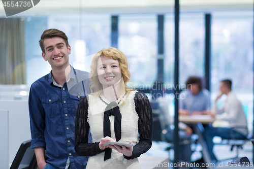 Image of Business People Working With Tablet in startup office