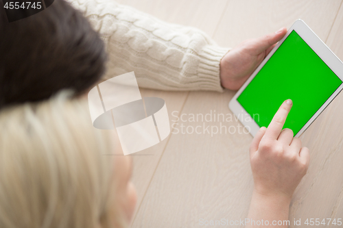 Image of Young Couple using digital tablet on cold winter day