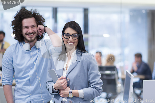 Image of Business People Working With Tablet in startup office