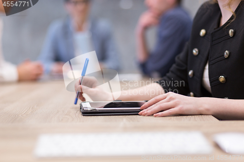 Image of businesswoman hand using pen