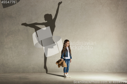 Image of Baby girl dreaming a dancing ballet on the stage. Childhood concept.