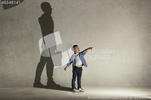 Image of The little boy dreaming about businessman profession