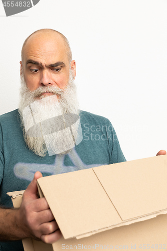 Image of skeptical looking bearded man with a carton box