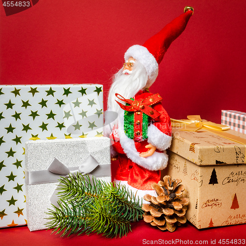 Image of Santa Claus figure standing on a golden gift box