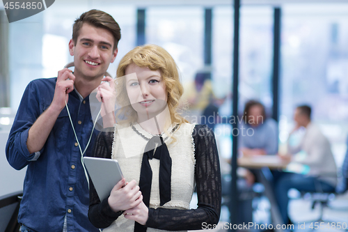 Image of Business People Working With Tablet in startup office