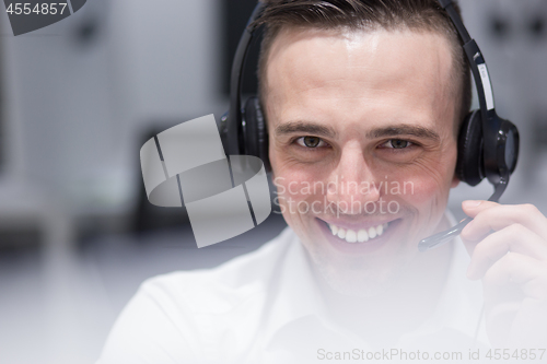 Image of male call centre operator doing his job