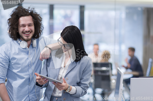 Image of Business People Working With Tablet in startup office