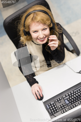 Image of female call centre operator doing her job top view