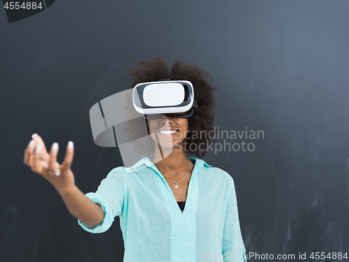 Image of black girl using VR headset isolated on gray background