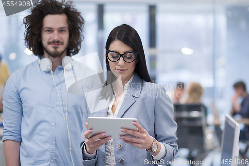 Image of Business People Working With Tablet in startup office