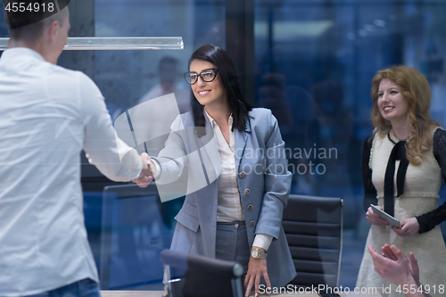 Image of cloasing the deal in modern office interior