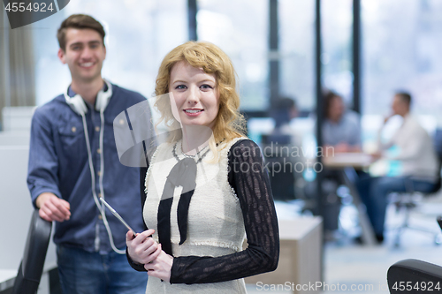 Image of Business People Working With Tablet in startup office
