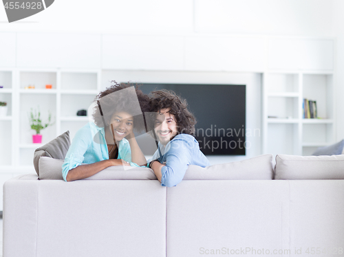 Image of young multiethnic couple in living room