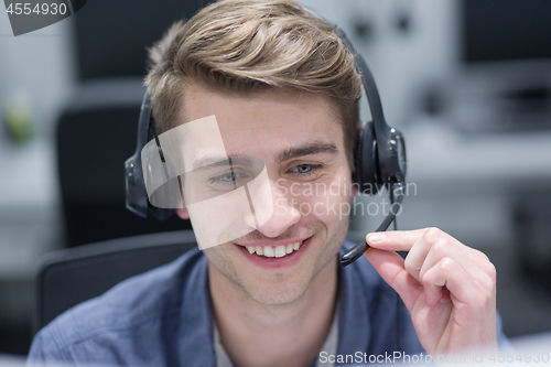 Image of male call centre operator doing his job