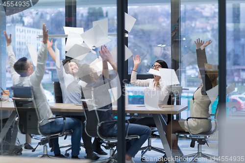 Image of startup Group of young business people throwing documents