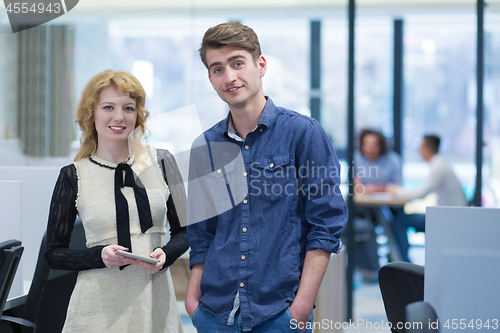 Image of Business People Working With Tablet in startup office