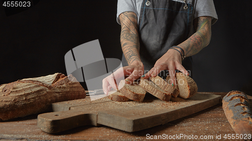 Image of Baker Holds Bran Bread