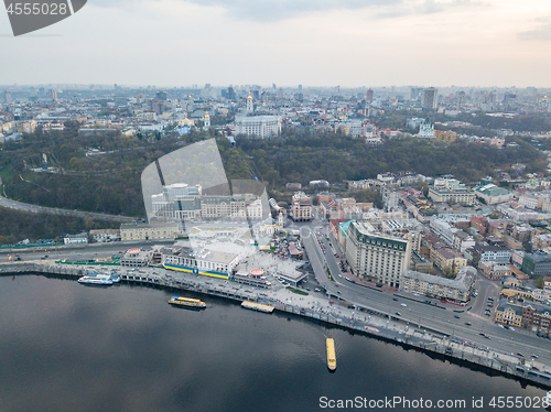 Image of The panoramic bird\'s eye view shooting from drone of the Podol district, the right bank of the Dnieper River and centre of Kiev, Ukraine summer evening at sunset on the background of the cloudy sky.