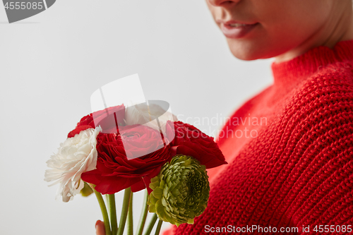 Image of Woman in a red sweatshirt with flowers Buttercup on a white background.