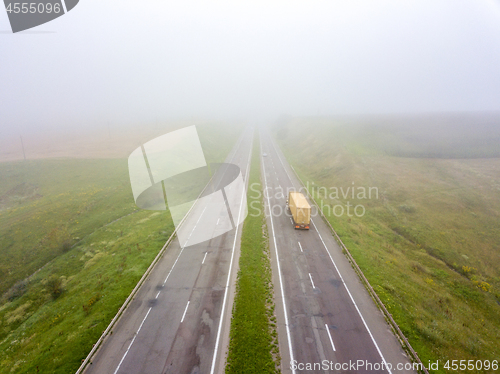 Image of Aerial view from the drone a misty morning on the road with a tr