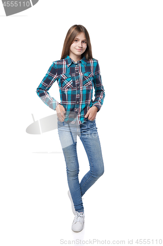 Image of Teen girl in checkered shirt standing casually