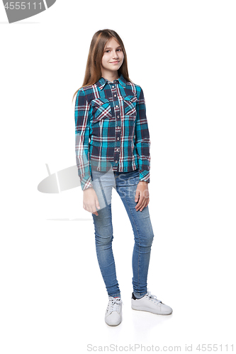 Image of Teen girl in checkered shirt standing casually