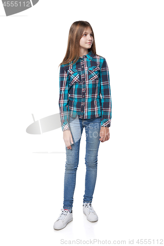 Image of Teen girl in checkered shirt standing casually