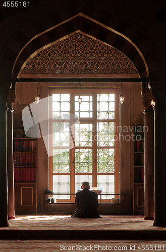 Image of male Muslim praying in the mosque