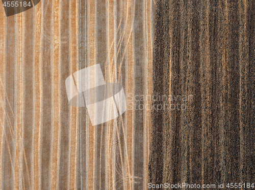 Image of A view from above on a piece of agricultural field after harvesting and on prepared for planting works.