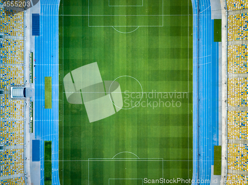 Image of KYIV, UKRAINE - July 19, 2018. NSC Olimpiysky. Aerial view from drone of construction of green football field, tribunes before the game. Top view