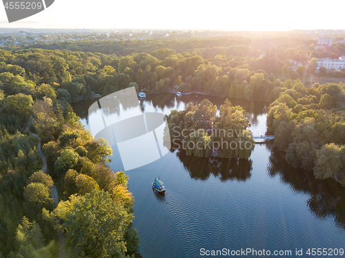 Image of Beautiful countryside landscape picturesque river with ships, green forest with summer sky at sunset. Aerial view from drone at Sofiyivsky park, city Uman, Ukraine