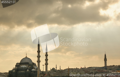 Image of The view of Ortakoy Mosque and the houses on the Bosphorus shore with rays of the sun