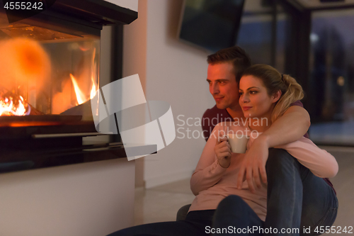 Image of happy couple in front of fireplace