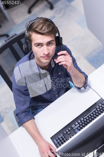 Image of male call centre operator doing his job top view